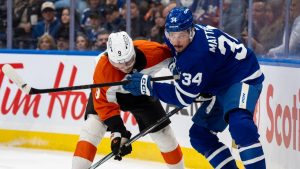 Toronto Maple Leafs centre Auston Matthews (34) battles with Philadelphia Flyers defenceman Jamie Drysdale (9) during second period NHL hockey action in Toronto, Sunday, Jan. 5, 2025. (Frank Gunn/CP)