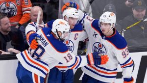 Edmonton Oilers centre Connor McDavid, centre, is congratulated after his goal against Boston Bruins goaltender Jeremy Swayman during the second period of an NHL hockey game, Tuesday, Jan. 7, 2025, in Boston. (Charles Krupa/AP Photo)