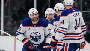 Edmonton Oilers center Leon Draisaitl, left, celebrates his empty net goal against the Seattle Kraken with teammates, including Viktor Arvidsson (33), Vasily Podkolzin (92) and Mattias Ekholm (14) during the third period of an NHL hockey game Saturday, Jan. 4, 2025, in Seattle. (Lindsey Wasson/AP)