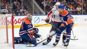 Washington Capitals' Connor McMichael (24) and Edmonton Oilers' Darnell Nurse (25) battle in front as goalie Stuart Skinner (74) makes the save during third period NHL action in Edmonton on Tuesday, January 21, 2025. (Jason Franson/CP)