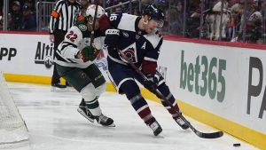 Minnesota Wild centre Marat Khusnutdinov (22) and Colorado Avalanche right wing Mikko Rantanen (96) in the third period of an NHL hockey game Monday, Jan. 20, 2025, in Denver. (David Zalubowski/AP)