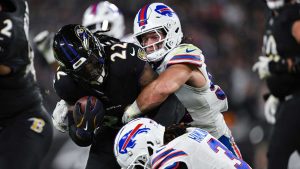 Baltimore Ravens running back Derrick Henry (22) is tackled by Buffalo Bills linebacker Baylon Spector, top, and safety Damar Hamlin (3) during the first half of an NFL football game. (Terrance Williams/AP)