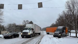 A truck is jackknifed as another spins its wheels on a slushy offramp off Interstate 285 northeast of downtown in Atlanta on Friday, Jan. 10, 2025. (Jeff Amy/AP)