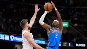 Oklahoma City Thunder guard Shai Gilgeous-Alexander (2) shoots as Cleveland Cavaliers forward Dean Wade, left, defends in the second half of an NBA basketball game, Wednesday, Jan. 8, 2025, in Cleveland. (Sue Ogrocki/AP Photo)