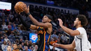 Oklahoma City Thunder guard Shai Gilgeous-Alexander (2) goes to the basket ahead of Brooklyn Nets forward Cameron Johnson, right, during the second half of an NBA basketball game Sunday, Jan. 19, 2025, in Oklahoma City. (Nate Billings/AP)