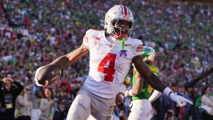 Ohio State wide receiver Jeremiah Smith (4) celebrates his touchdown against Oregon during the first half in the quarterfinals of the Rose Bowl College Football Playoff, Wednesday, Jan. 1, 2025, in Pasadena, Calif. (Mark J. Terrill/AP Photo)