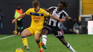 Atalanta's Charles De Ketelaere, left, and Udinese's Filip Benkovic battle for the ball during the Serie A soccer match between Udinese and Atalanta at the Bluenergy Stadium in Udine, Italy, Saturday Jan. 11, 2025. (Andrea Bressanutti/LaPresse via AP)