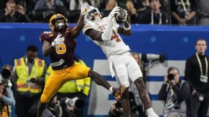 Texas defensive back Andrew Mukuba (4) intercepts a pass intended for Arizona State wide receiver Melquan Stovall (5) during overtime in the quarterfinals of a College Football Playoff game. (John Bazemore/AP)