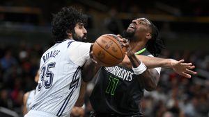 Minnesota Timberwolves centre Naz Reid (11) is fouled by Orlando Magic center Goga Bitadze (35) while going up to shoot during the second half of an NBA basketball game, Thursday, Jan. 9, 2025, in Orlando, Fla. (Phelan M. Ebenhack/AP Photo)