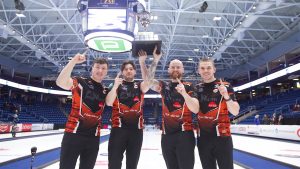 Euan Kyle, Duncan McFadzean, Robin Brydone and Ross Whyte celebrate with the Masters trophy on Jan. 19, 2025, in Guelph, Ont. (Anil Mungal/GSOC)