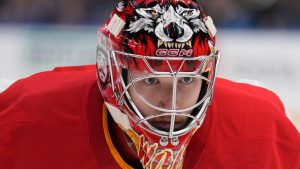 Calgary Flames goaltender Dustin Wolf (32) skates back to his position during a timeout in the second period of an NHL hockey game against the St. Louis Blues Thursday, Jan. 16, 2025, in St. Louis. (Jeff Roberson/AP Photo)