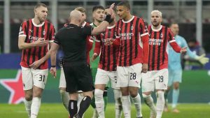 AC Milan's players argue with Referee Szymon Marciniak of Poland after he sent off AC Milan's Theo Hernandez, right, during Champions League, playoff second leg soccer match between AC Milan and Feyenoord, at the San Siro stadium in Milan, Italy, Tuesday, Feb.18, 2025. (Luca Bruno/AP)