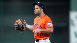 Houston Astros second baseman Jose Altuve handles his glove after committing a throwing error that allowed Detroit Tigers' Spencer Torkelson to reach first in the second inning of Game 2 of an AL Wild Card Series baseball game Wednesday, Oct. 2, 2024, in Houston. (Kevin M. Cox/AP)