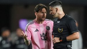 Inter Miami forward Lionel Messi, left, talks with the referee during the first half of an MLS soccer match against New York City FC, Saturday, Feb. 22, 2025, in Fort Lauderdale, Fla. (AP Photo/Rebecca Blackwell)