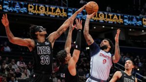 Washington Wizards forward Justin Champagne (9) goes up to shoot against Brooklyn Nets center Nic Claxton (33), guard Killian Hayes (7), and forward Jalen Wilson (22) during the first half of an NBA game Monday, Feb. 24, 2025. (AP Photo/Jess Rapfogel)