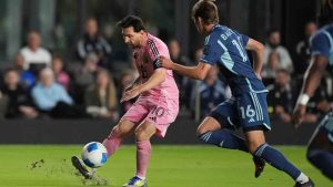 Inter Miami forward Lionel Messi (10) passes, defended by Sporting Kansas City midfielder Jacob Bartlett (16) during the first half of a CONCACAF Champions Cup soccer match, Tuesday, Feb. 25, 2025, in Fort Lauderdale, Fla. (Rebecca Blackwell/AP)