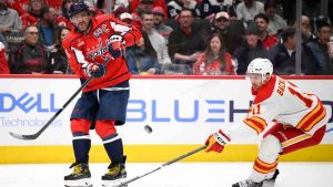 Washington Capitals left wing Alex Ovechkin passes the puck against Calgary Flames center Mikael Backlund during the second period of an NHL hockey game, Tuesday, Feb. 25, 2025, in Washington. (Nick Wass/AP)