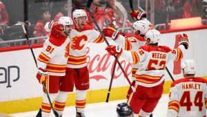 Calgary Flames left wing Jonathan Huberdeau celebrates his goal with center Nazem Kadri (91) and others during the third period of an NHL hockey game against the Washington Capitals, Tuesday, Feb. 25, 2025, in Washington. (Nick Wass/AP)