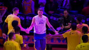 Los Angeles Lakers guard Luka Doncic, center, is introduced before an NBA basketball game against the Dallas Mavericks, Tuesday, Feb. 25, 2025, in Los Angeles. (AP Photo/Kyunsung Gong)