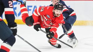 Canada's Josh Morrissey (44) is tripped by United States' Jake Guentzel (59) during first period 4 Nations Face-Off hockey action in Montreal, Saturday, February 15, 2025. (Graham Hughes/CP)