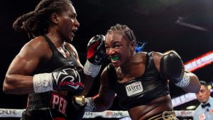 Claressa Shields, right, exchanges punches with Danielle Perkins during the undisputed heavyweight title match on Sunday, Feb. 2, 2025 at Dort Financial Center in Flint. (Jake May/The Flint Journal via AP)