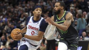 Washington Wizards guard Bilal Coulibaly, left, work around Minnesota Timberwolves guard Mike Conley during the second half of an NBA basketball game Saturday, Feb. 1, 2025, in Minneapolis. (Matt Krohn/AP)
