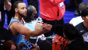 Golden State Warriors guard Stephen Curry shakes hands with a person in the stands after the NBA All-Star basketball game Sunday, Feb. 16, 2025, in San Francisco. (Jed Jacobsohn/AP)