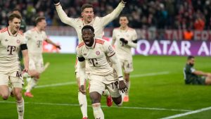 Bayern's Alphonso Davies, centre, celebrates after scoring his side's opening goal during the Champions League playoff second leg soccer match between FC Bayern Munich and Celtic Glasgow at the Allianz Arena in Munich, Germany, Tuesday, Feb. 18, 2025. (Matthias Schrader/AP)