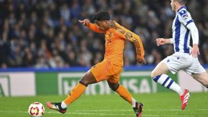 Real Madrid's Endrick, left, scores his side's opening goal during the Spanish Copa del Rey match between Real Sociedad and Real Madrid at the Reale Arena in San Sebastian, Spain, Wednesday, Feb. 26, 2025. (AP/Miguel Oses)