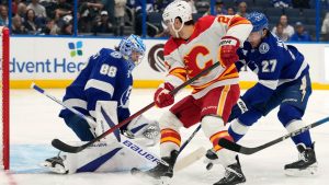 Tampa Bay Lightning goaltender Andrei Vasilevskiy (88) and defenseman Ryan McDonagh (27) team up to stop a shot by Calgary Flames right wing Matt Coronato (27, center) during the first period of an NHL hockey game Thursday, Feb. 27, 2025, in Tampa, Fla. (Chris O'Meara/AP)