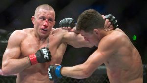 In this March 16, 2013 file photo, Georges St-Pierre, left, lands a blow to Nick Diaz, from the United States, during their UFC 158 welterweight mixed martial arts title fight in Montreal. (Graham Hughes/CP)