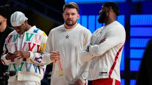 Luka Doncic, center, talks with LeBron James, right, before the start of the NBA All-Star basketball game in Indianapolis. (Darron Cummings/AP)