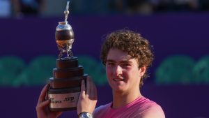 Brazil's Joao Fonseca poses with the trophy after defeating Argentina's Francisco Cerundolo during a men's doubles final match at the Argentina Open ATP tennis tournament at Guillermo Vilas Stadium in Buenos Aires, Argentina, Sunday, Feb. 16, 2025. (AP Photo/Gustavo Garello)