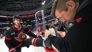 Equipment manager John Forget of the Ottawa Senators sharpens the skates of Artem Zub #2 during warmup prior to a game against the New York Islanders at Canadian Tire Centre on November 24, 2023 in Ottawa, Ontario, Canada. (Photo by André Ringuette/NHLI via Getty Images)