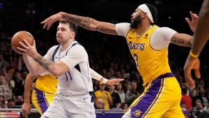 Dallas Mavericks guard Luka Doncic, left, drives to the basket as Los Angeles Lakers forward Anthony Davis defends during the second half of an NBA basketball game Wednesday, Nov. 22, 2023, in Los Angeles. (Marcio Jose Sanchez/AP)