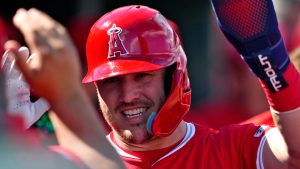 Los Angeles Angels' Mike Trout hight fives teammates in the dugout during a spring training baseball game against the San Francisco Giants, Monday, Feb. 24, 2025, in Tempe, Ariz. (Matt York/AP)