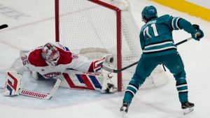 Montreal Canadiens goaltender Sam Montembeault, left, defends against a shot by San Jose Sharks centre Macklin Celebrini (71) during the third period of an NHL hockey game in San Jose, Calif., Tuesday, Feb. 4, 2025. (Jeff Chiu/AP)