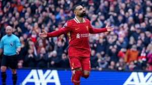 Liverpool's Mohamed Salah celebrates after scoring his side' second goal during the English Premier League soccer match between Liverpool and Wolverhampton Wanderers. (Peter Byrne/PA via AP)