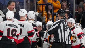 Ottawa Senators head coach Travis Green, top left, talks to officials during the first period of an NHL hockey game against the Nashville Predators, Monday, Feb. 3, 2025, in Nashville, Tenn. (George Walker IV/AP)