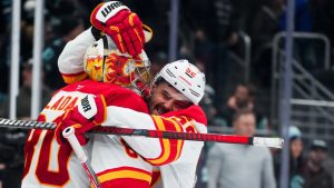 Calgary Flames defenceman MacKenzie Weegar, right, greets goaltender Dan Vladar as they celebrate a 3-2 win over the Seattle Kraken in an NHL hockey game Sunday, Feb. 2, 2025, in Seattle. (Lindsey Wasson/CP)