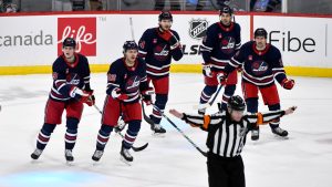 Winnipeg Jets argue a disallowed goal against the Carolina Hurricanes with the ref during the third period of their NHL hockey game in Winnipeg, Tuesday February 4, 2025. The disallowed goal was later ruled a goal. (Fred Greenslade/CP)