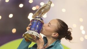 Amanda Anisimova of the United States holds the trophy after winning the Qatar Open tennis tournament in Doha, Qatar, on Saturday, Feb. 15, 2025. (Hussein Sayed/AP)