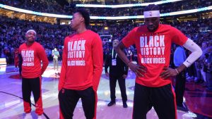 Toronto Raptors forward Bruce Brown, left to right, forward Scottie Barnes and forward Chris Boucher react as fans boo the American national anthem before first half NBA action against the LA Clippers in Toronto on Sunday, Feb. 2, 2025. (Frank Gunn/CP)