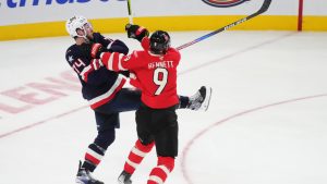 Canada's Sam Bennett (9) checks United States' Jaccob Slavin (74) during third period 4 Nations Face-Off hockey action in Montreal on Saturday, Feb. 15, 2025. (Christinne Muschi/CP)