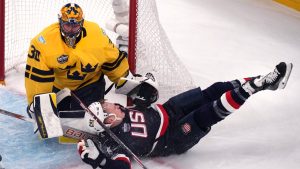 United States' Brady Tkachuk slams into the post while chasing the puck towards Sweden goaltender Samuel Ersson during the first period of a 4 Nations Face-Off hockey game, Monday, Feb. 17, 2025, in Boston. (Charles Krupa/AP Photo)