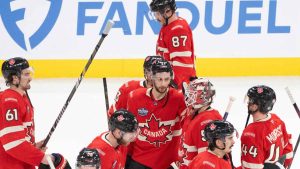 Canada players rally around goaltender Jordan Binnington (50) following their loss to the United States at 4 Nations Face-Off. (Christinne Muschi/CP)