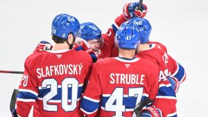 Montreal Canadiens' Nick Suzuki, right, celebrates with teammates after scoring against the San Jose Sharks during first period NHL hockey action in Montreal, Thursday, February 27, 2025. (Graham Hughes/THE CANADIAN PRESS)