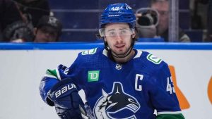 Vancouver Canucks' Quinn Hughes looks on during a stoppage after being checked to the ice during third period NHL hockey action against the Anaheim Ducks. (Darryl Dyck/THE CANADIAN PRESS)