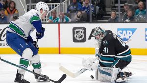 San Jose Sharks goaltender Vitek Vanecek (41) blocks a shot on goal by Vancouver Canucks left wing Drew O'Connor, left, during the second period of an NHL hockey game in San Jose, Calif., Thursday, Feb. 6, 2025. (Tony Avelar/AP)