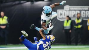 Toronto Argonauts' Ka'Deem Carey (25) is upended by Winnipeg Blue Bombers' Michael Griffin (32) during first half CFL football action at the 111th Grey Cup in Vancouver on Sunday, November 17, 2024. (Nathan Denette/CP)